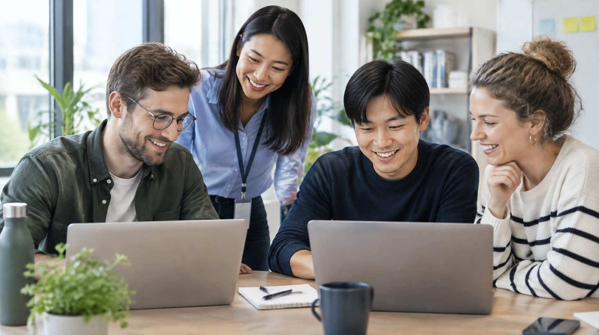Colleagues at laptops in a modern office